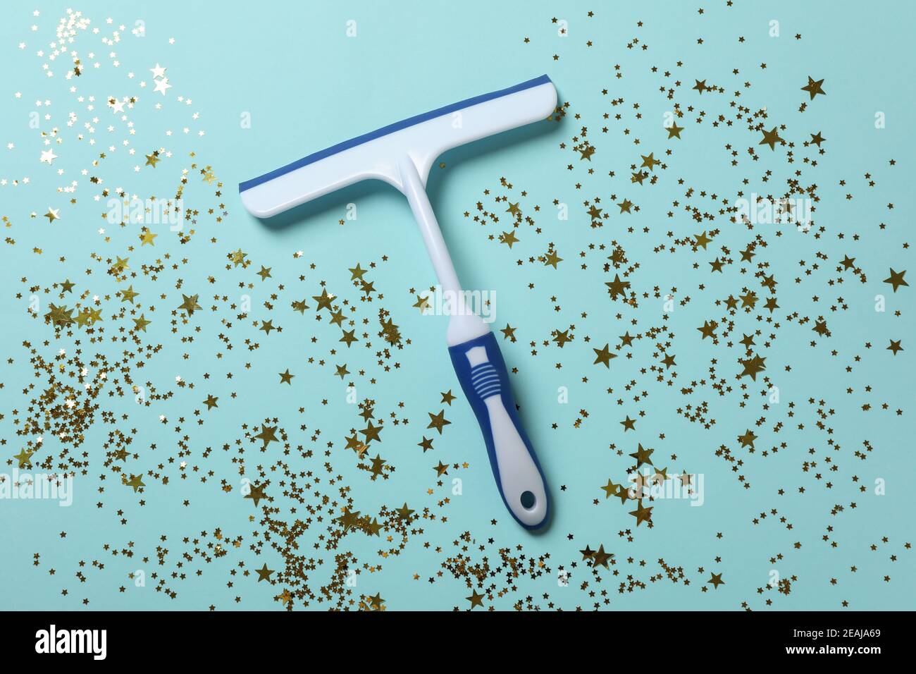 Window cleaning squeegee on blue background with glitter Stock Photo