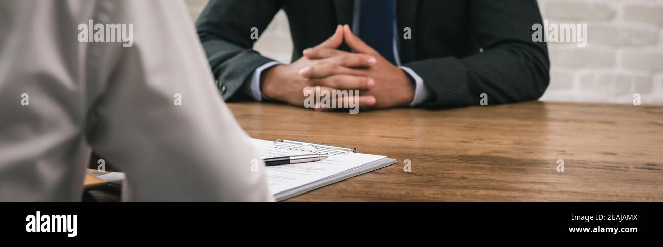 Two businessmen secretly having meeting for bribery and corruption, panramic banner proportion Stock Photo