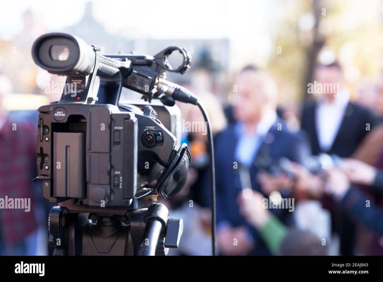 Filming news conference with television camera Stock Photo