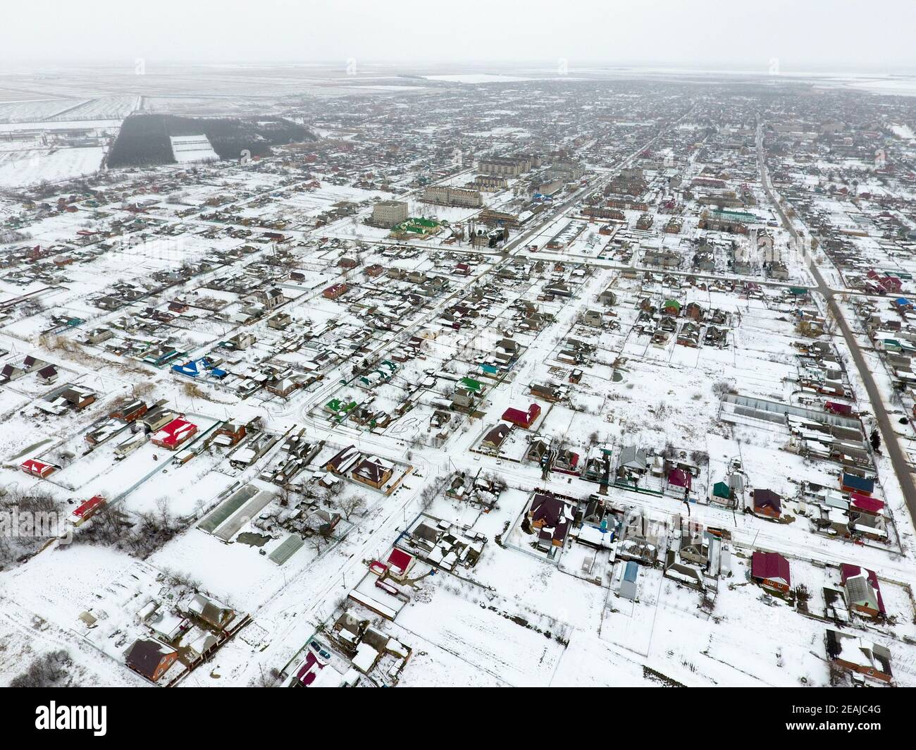 Winter view from the bird's eye view of the village. The streets are covered with snow Stock Photo