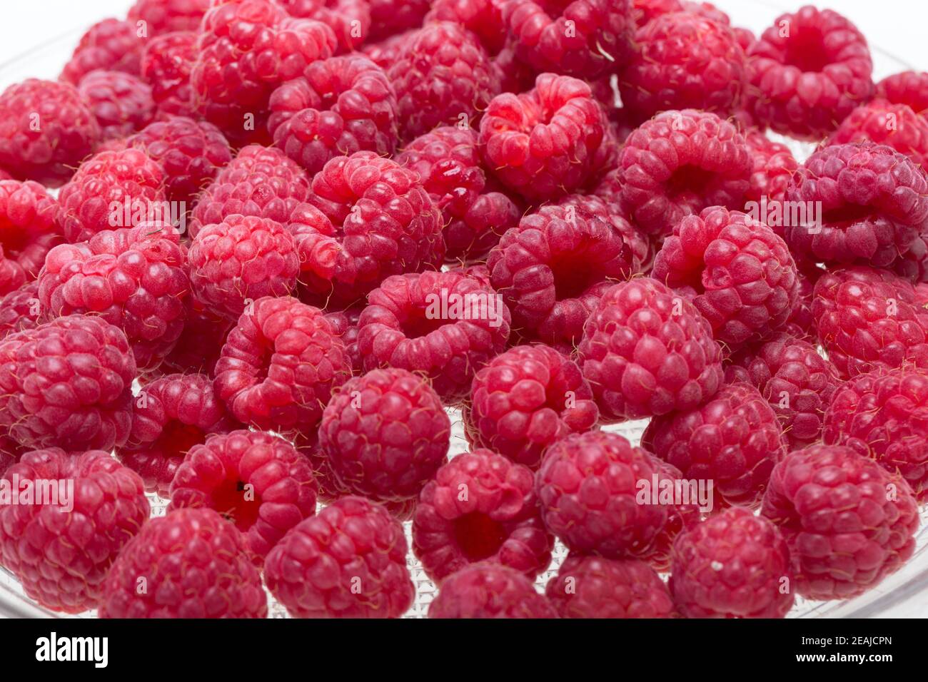 A beautiful selection of freshly picked ripe red raspberries. Stock Photo
