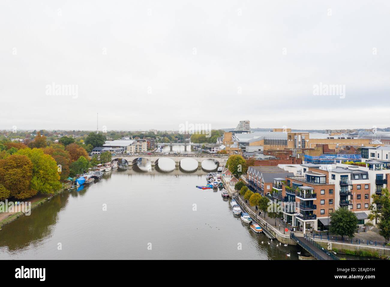 Aerial Landscape View of a River with a Bridge Over it and Under a Cloudy Sky Stock Photo