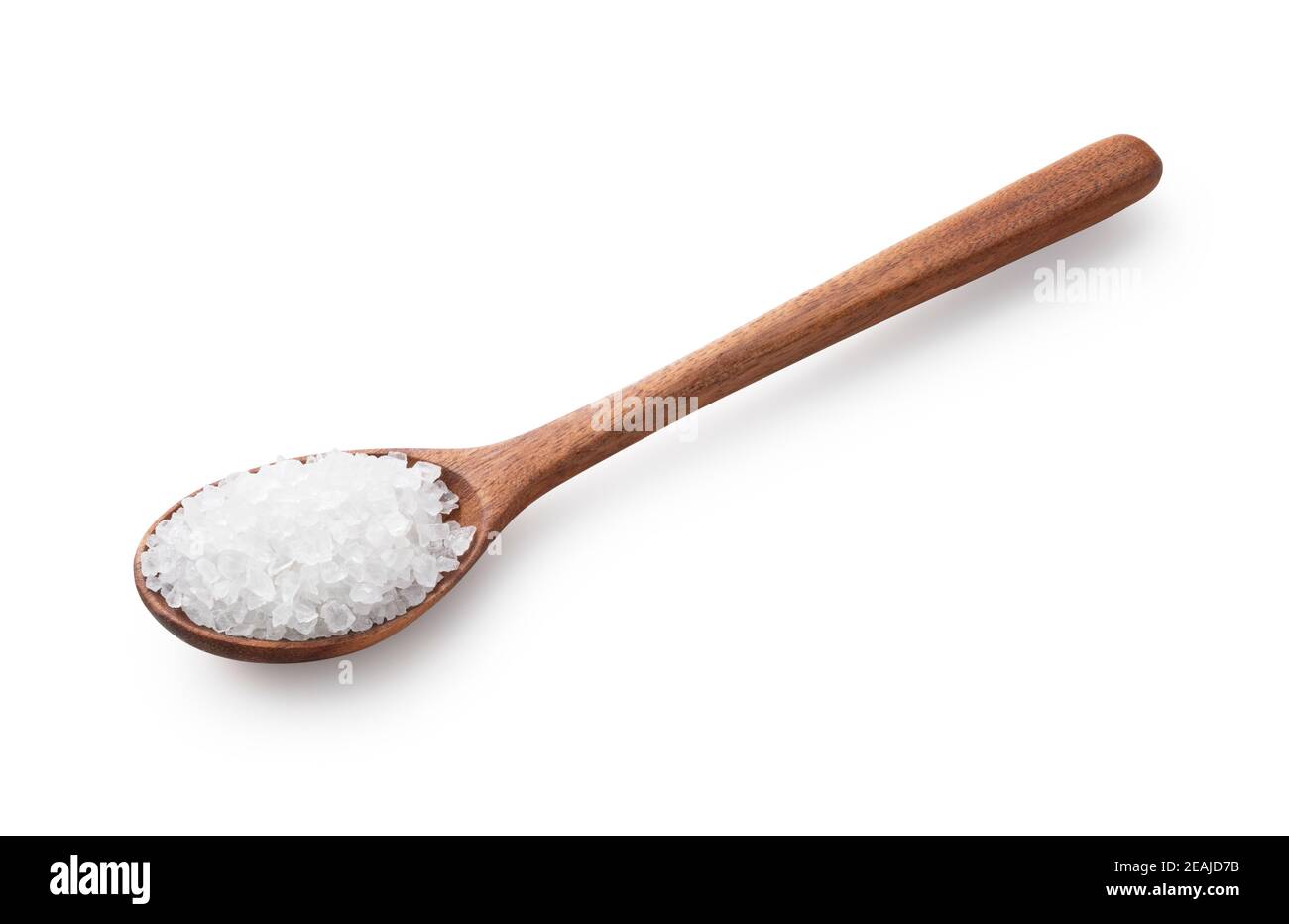 Himalayan rock salt in a spoon placed on a white background Stock Photo