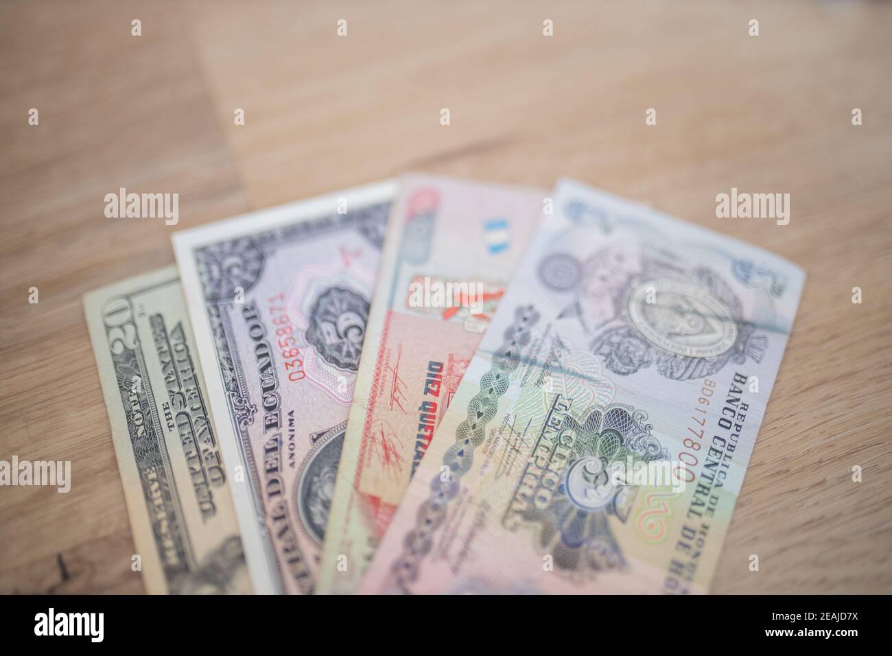 Twenty-Dollar, Five Sucres, Ten Quetzales, and Five Lempiras Bills on a Table Stock Photo