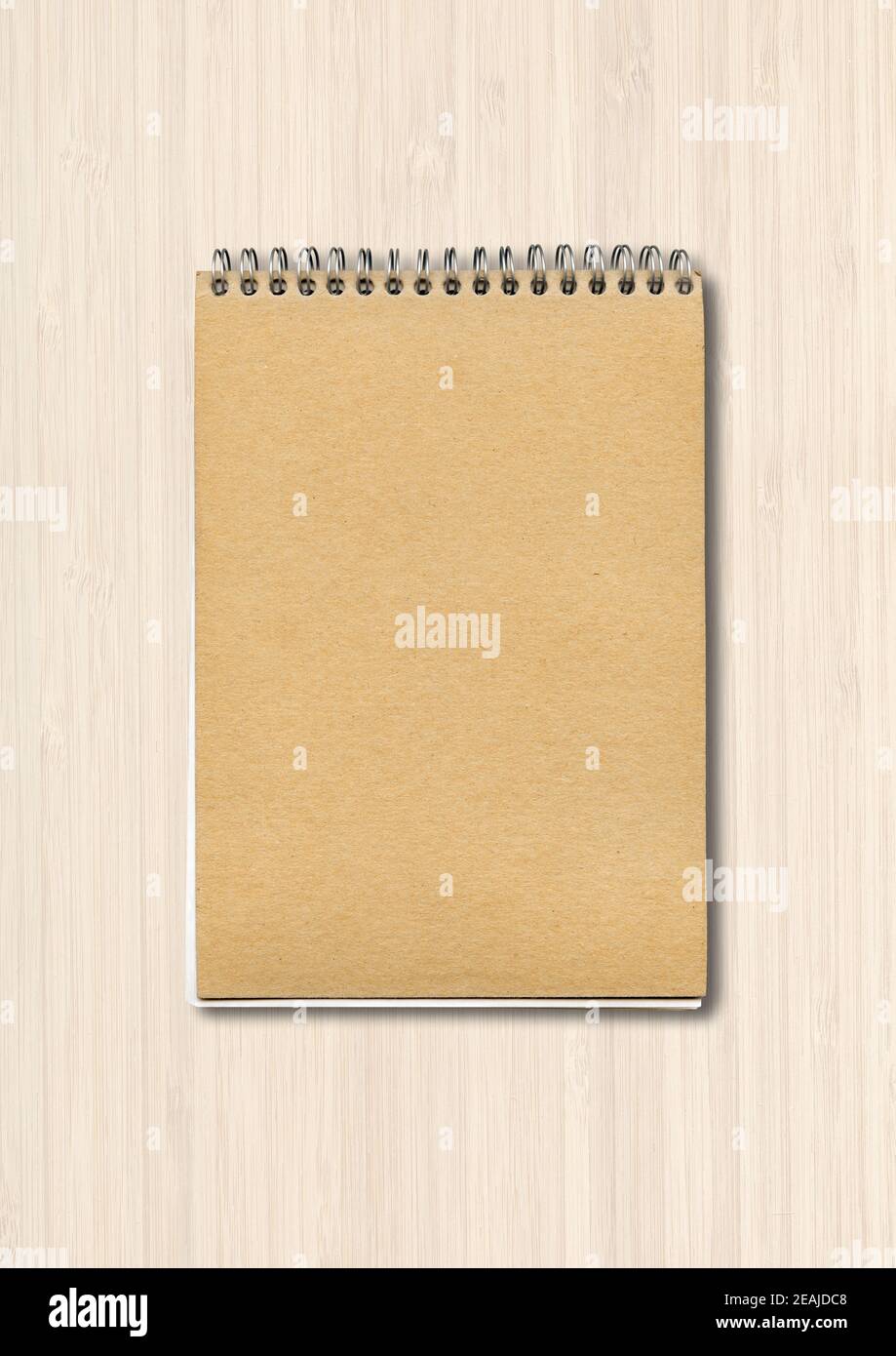Spiral closed notebook mockup on white wood background Stock Photo