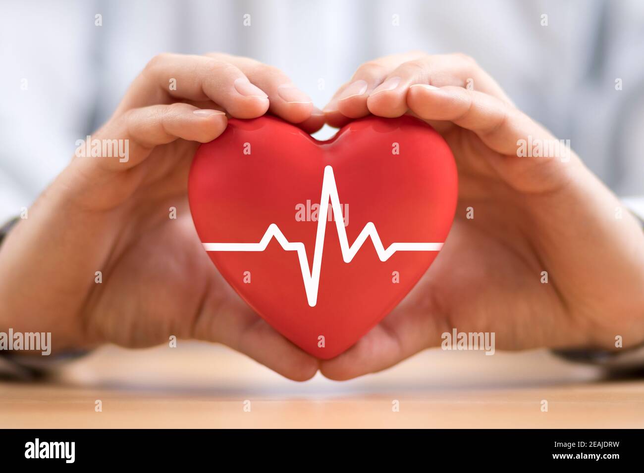 Heart pulse in hands. Health insurance concept Stock Photo - Alamy