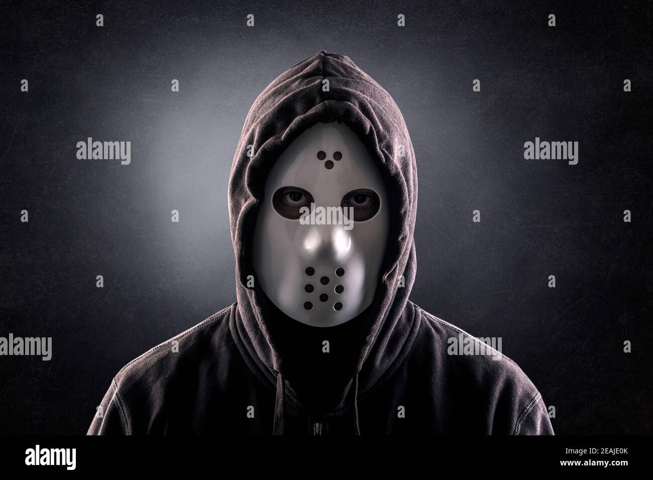 Hooded maniac or criminal in mask Stock Photo