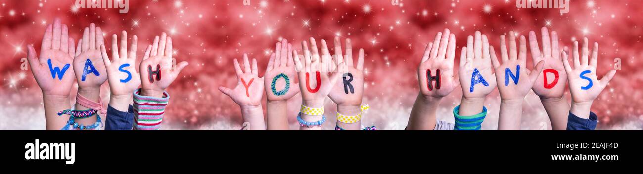 Children Hands Building Word Wash Your Hands, Red Christmas Background Stock Photo