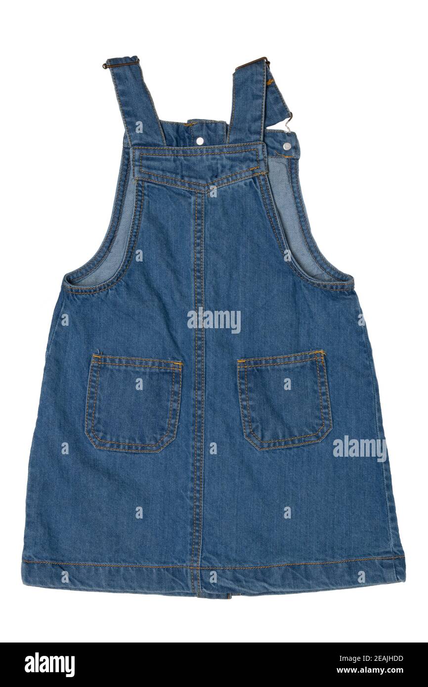 Closeup of cute sleeveless blue denim overall dress for little child girl isolated on a white background. Jeans fashion for kids. Back view. Stock Photo
