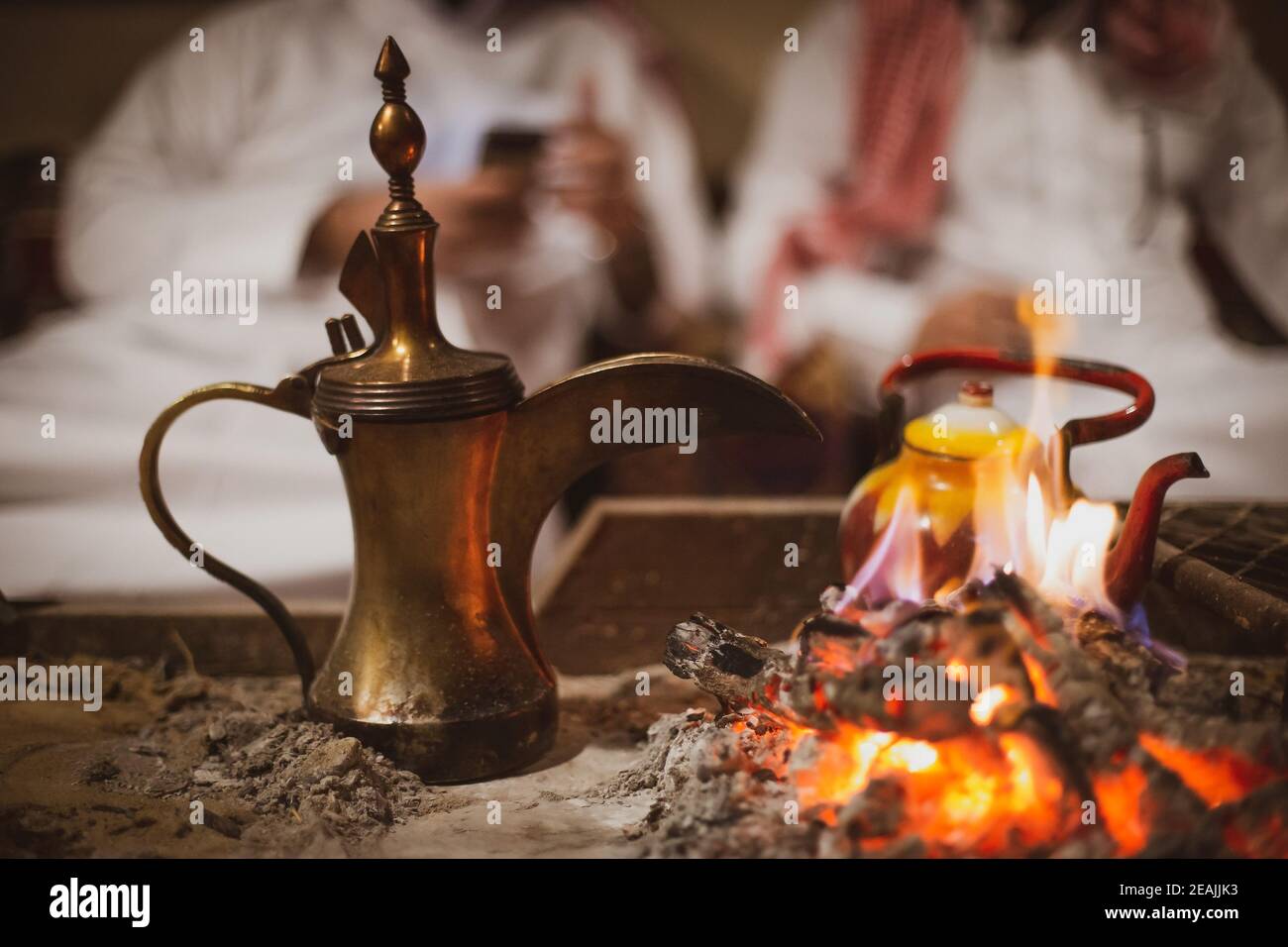 Traditional arabic coffee pot named dallah in fireplace inside the tent Stock Photo