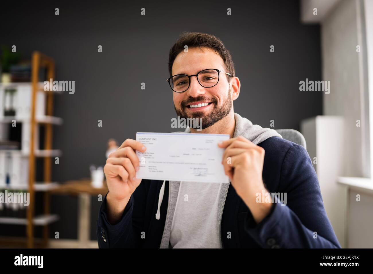 Holding Paycheck Or Payroll Check Or Insurance Cheque Stock Photo Alamy