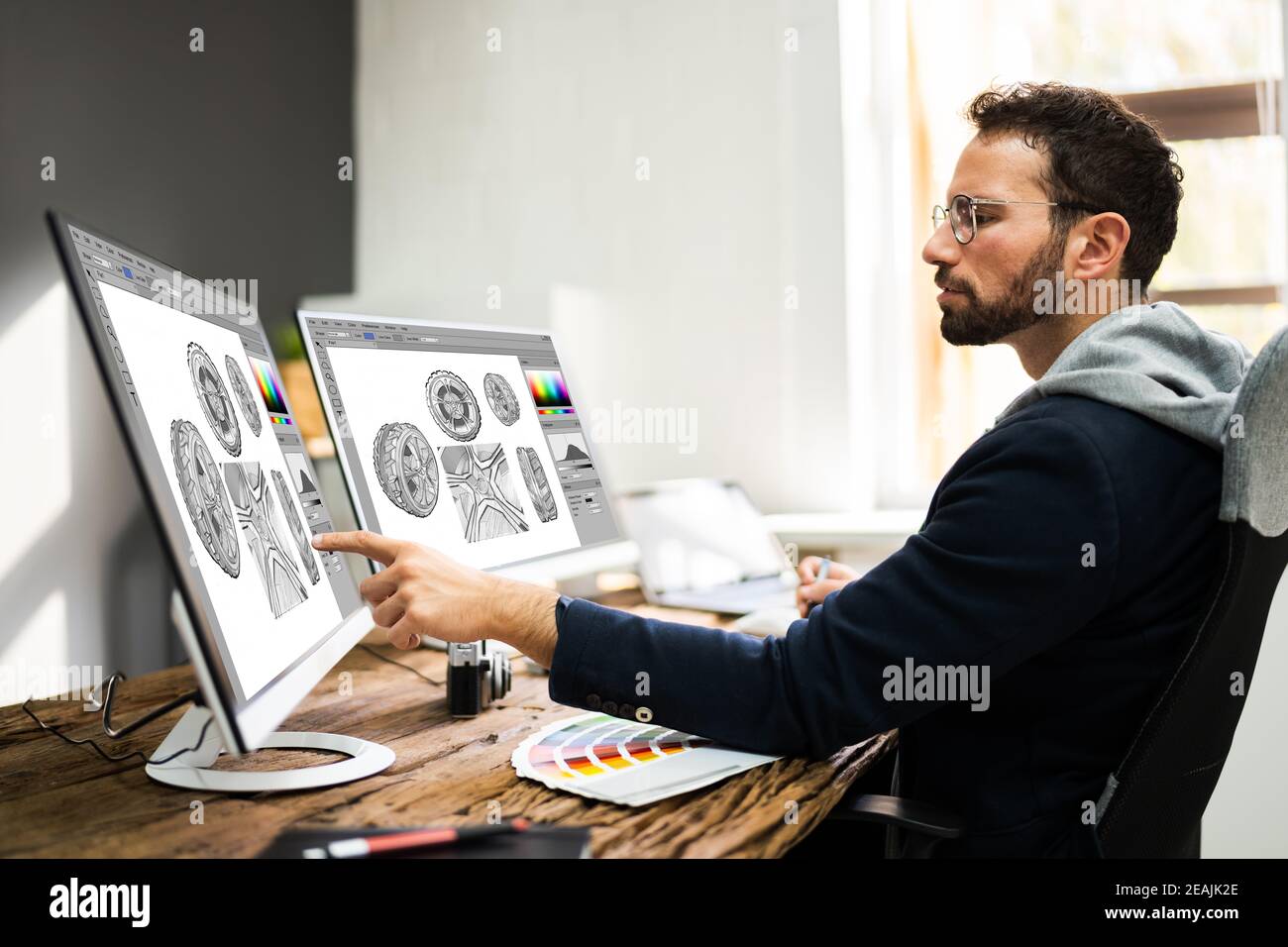Designer Editing Photos Stock Photo - Alamy