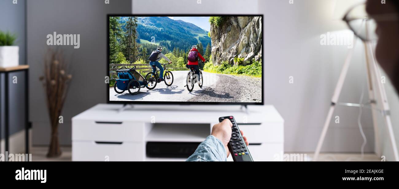 Watching TV Movie On Couch Stock Photo