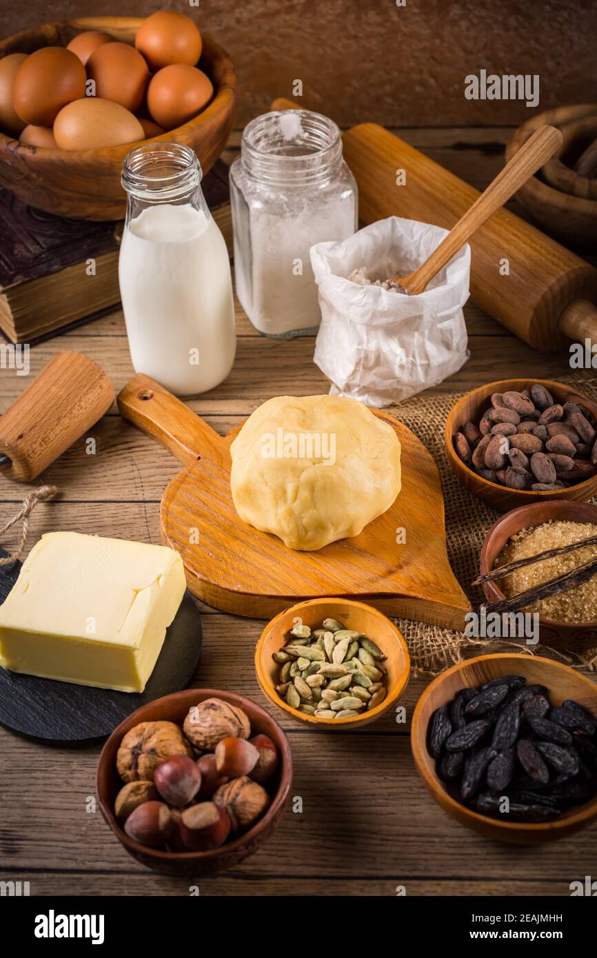 Assortment of baking ingredients and kitchen utensils in vintage wooden style Stock Photo