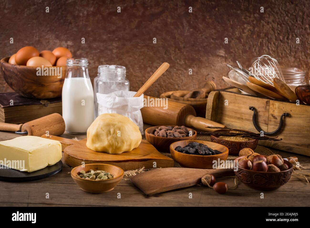 Assortment of baking ingredients and kitchen utensils in vintage wooden style Stock Photo