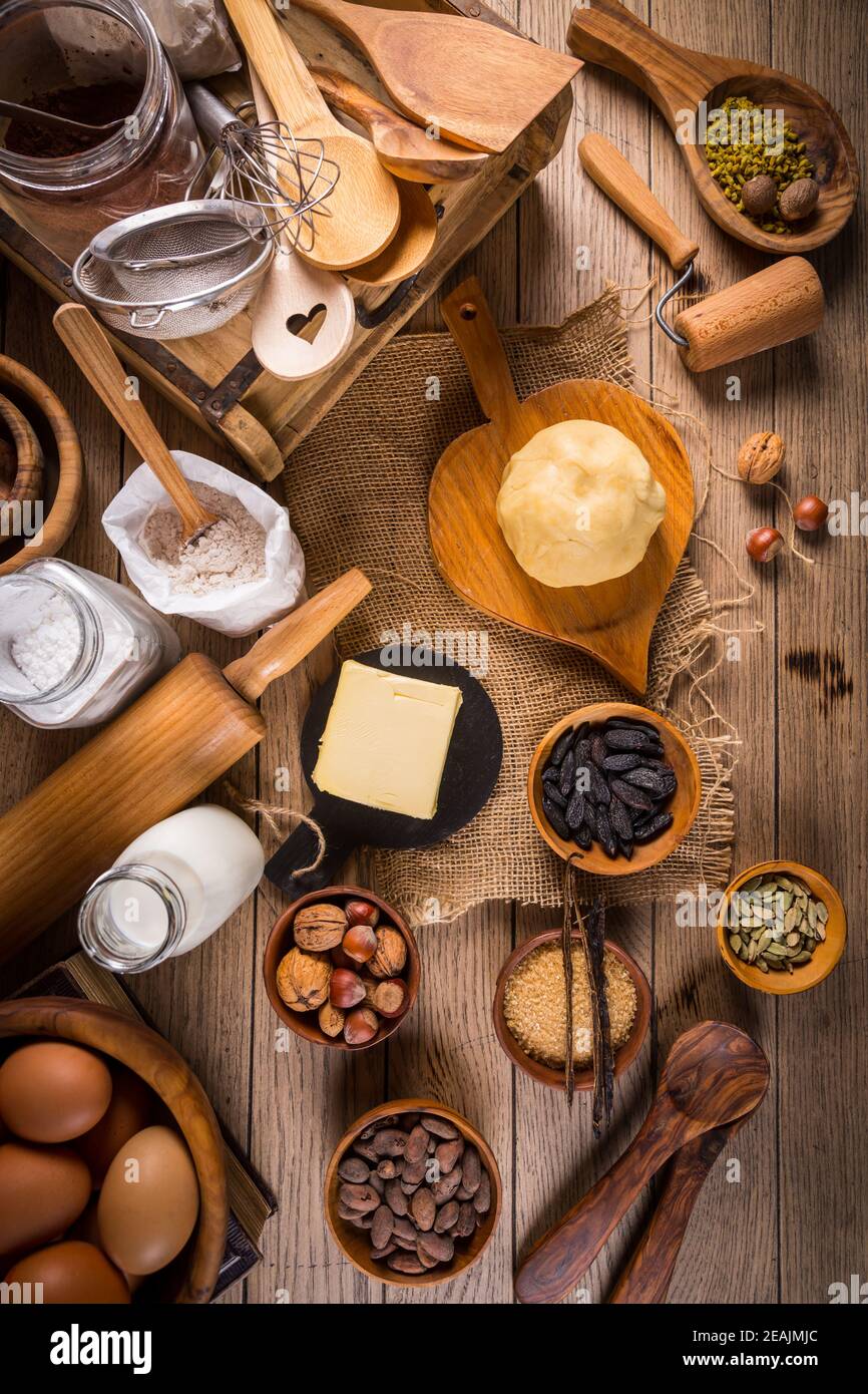 Assortment of baking ingredients and kitchen utensils in vintage wooden style Stock Photo