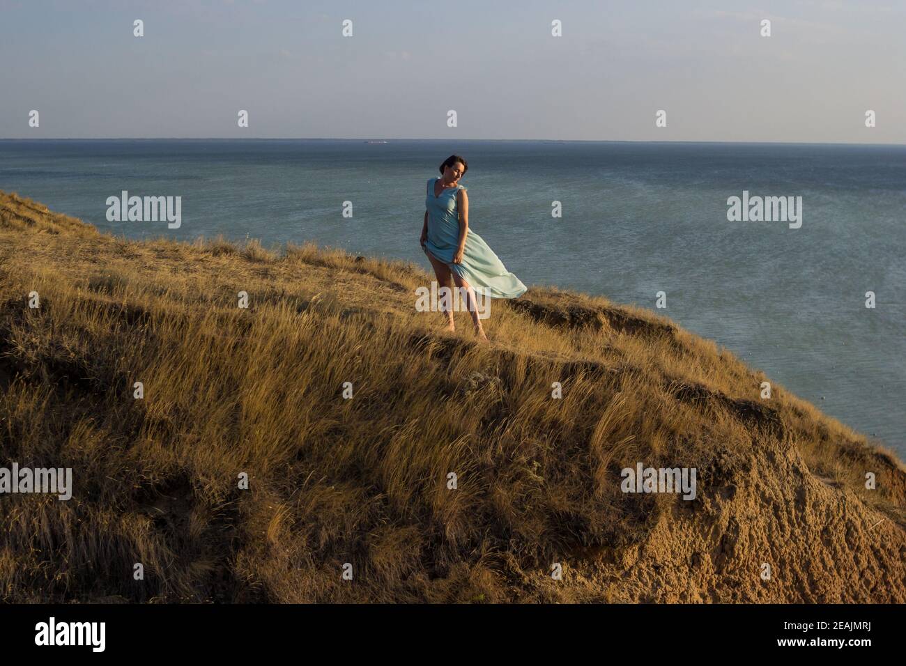 Woman standing sea on windy hi-res stock photography and images - Alamy