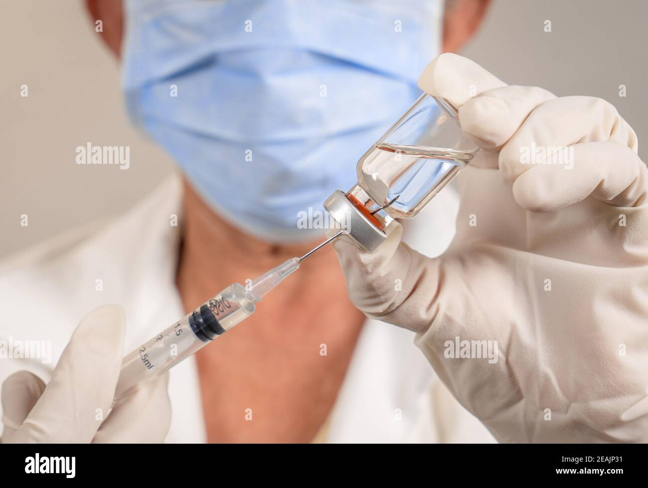 Extracting the liquid from a vaccine container Stock Photo