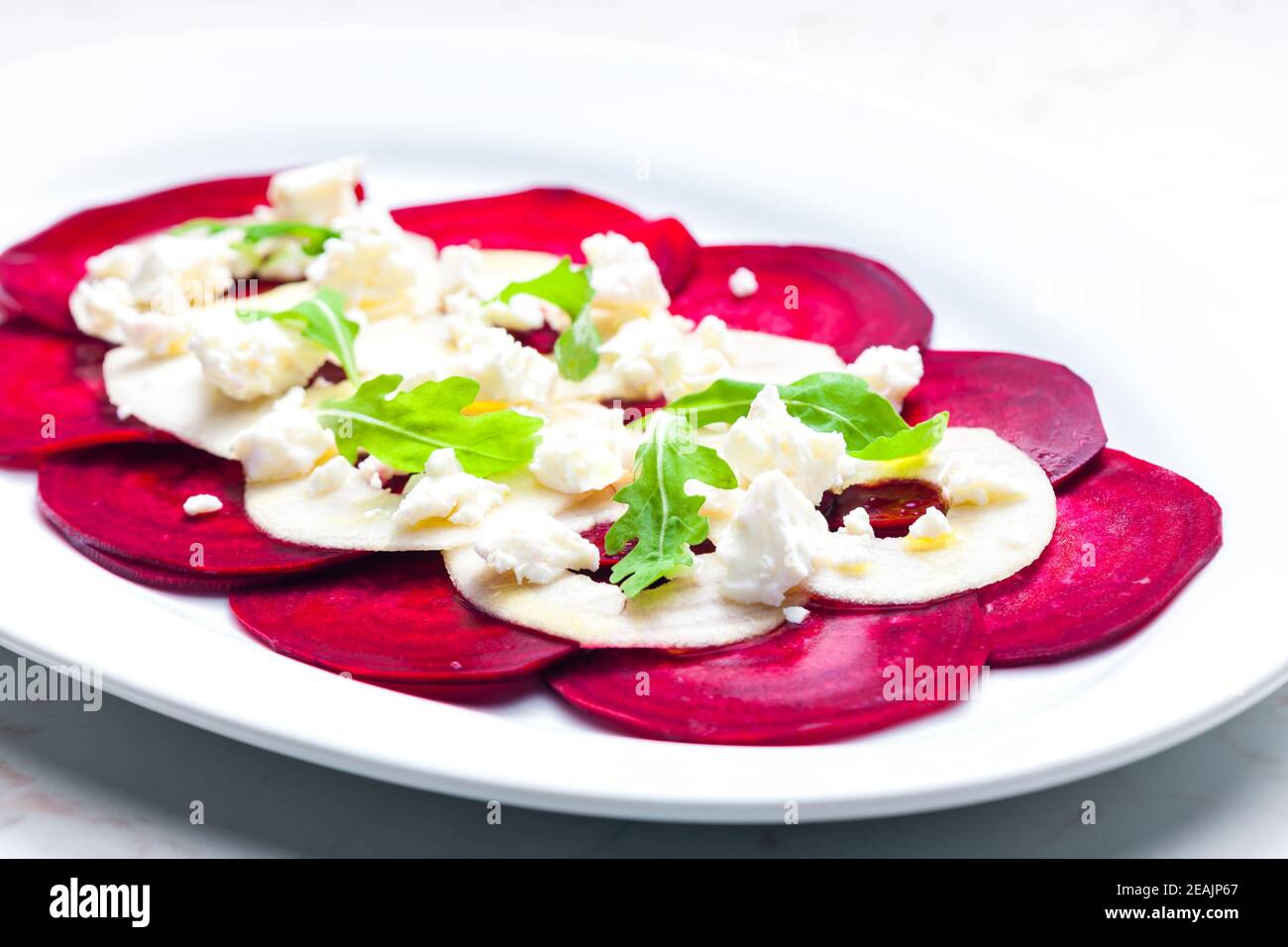 fresh beetroot and apple salad with fresh goat cheese and arugula Stock Photo