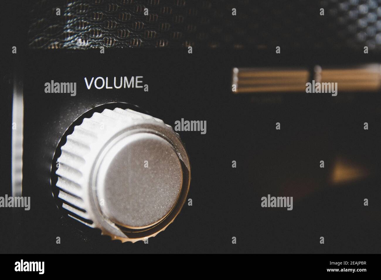 Volume wheel on an old and vintage analog radio. Close-up and detail. Copy Space. Stock Photo