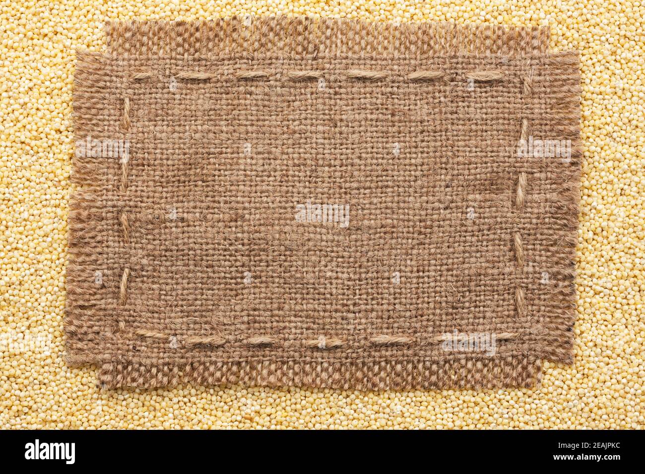 Frame of burlap  lying on a millet  background Stock Photo