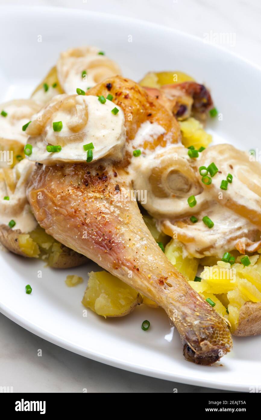 chicken leg on creamy onion sauce with potatoes Stock Photo Alamy
