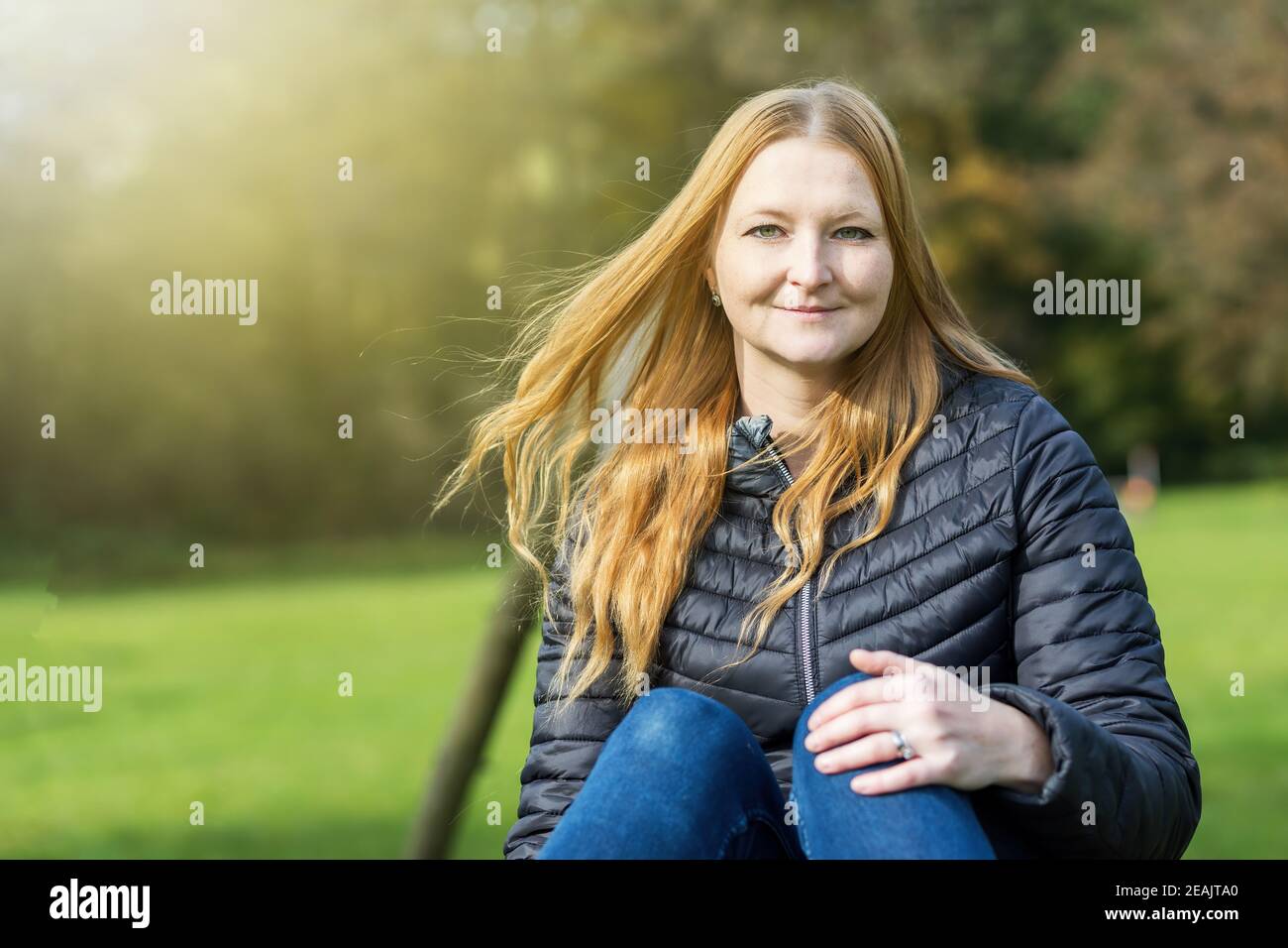 Portrait of red haired young woman posing outdoors Stock Photo - Alamy