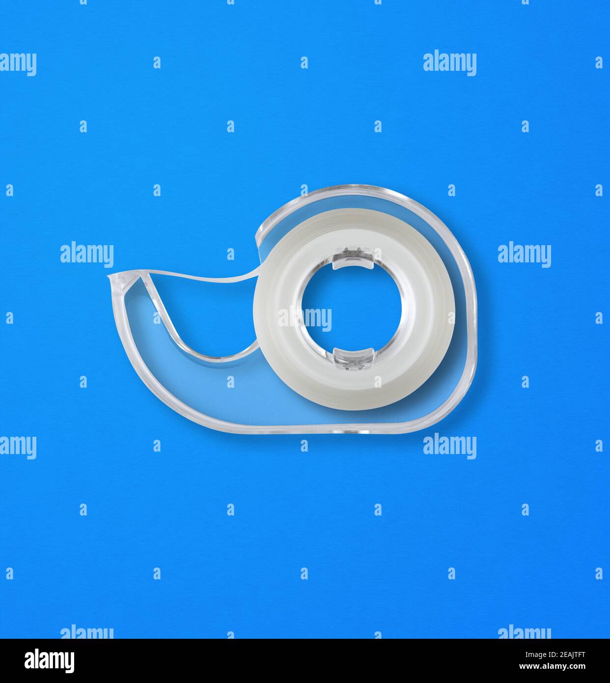 Scotch tape dispenser isolated on blue background Stock Photo