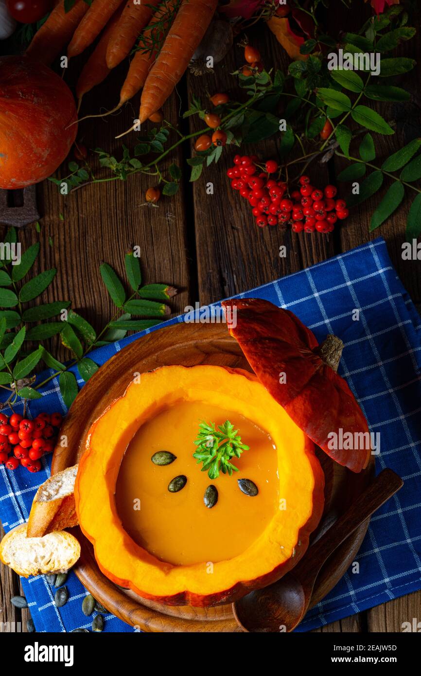 Delicious autumn pumpkin soup with baguette Stock Photo
