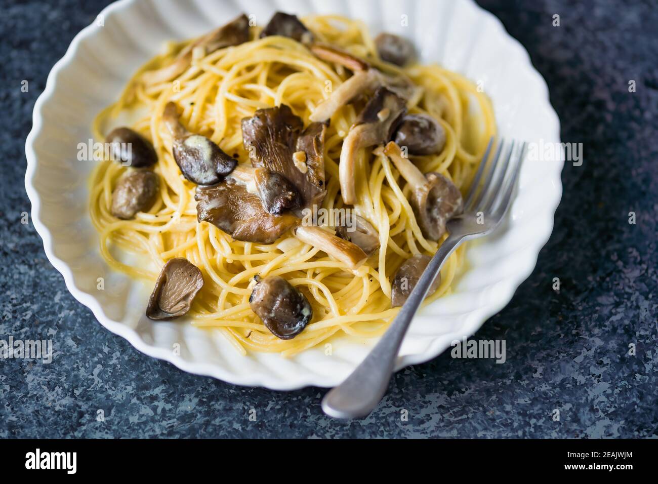 rustic italian spaghetti pasta in mushroom cream sauce Stock Photo Alamy