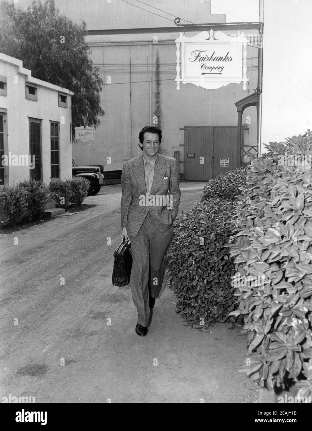 DOUGLAS FAIRBANKS Jr leaves his production office on the Universal Studios Lot at the end of a day's filming candid during making of THE EXILE 1947 director MAX OPHULS producer Douglas Fairbanks Jr Fairbanks Company / Universal - International Stock Photo