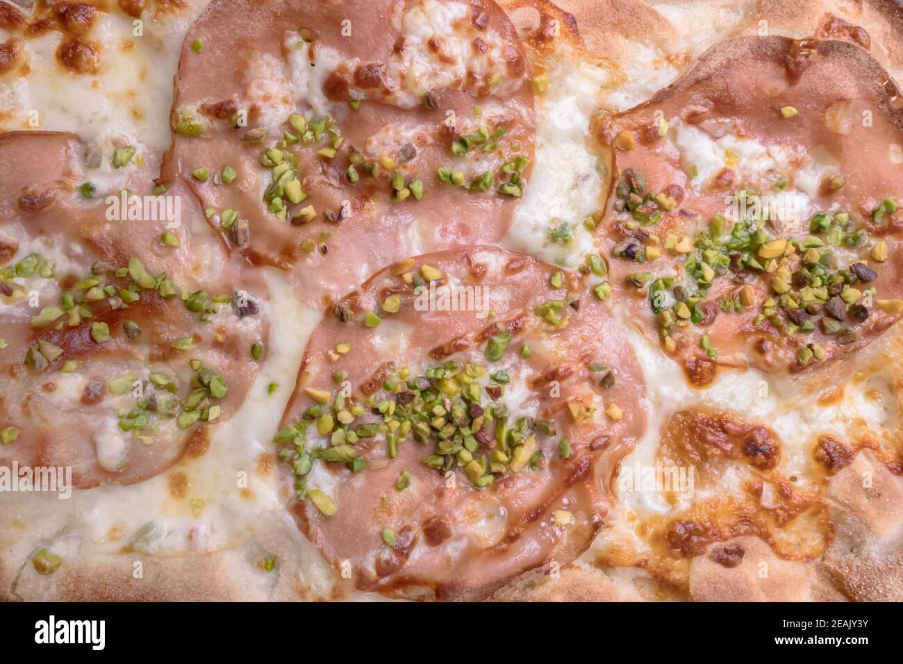 Pizza with mortadella and pistachios Stock Photo