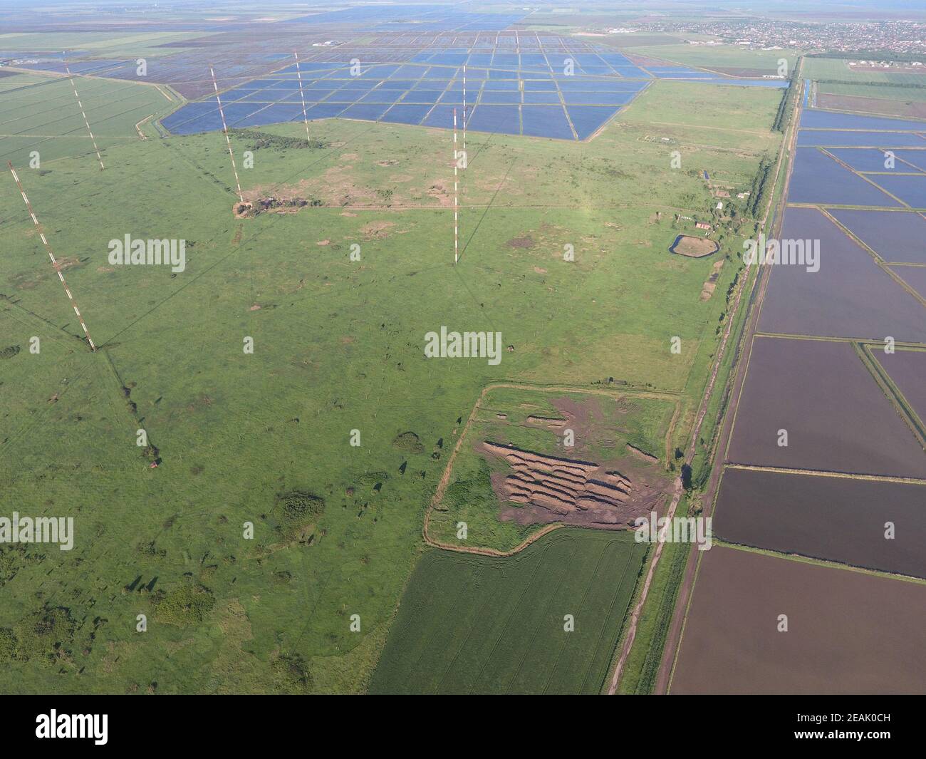 Masts longwave antennas communication among the rice fields flooded Stock Photo