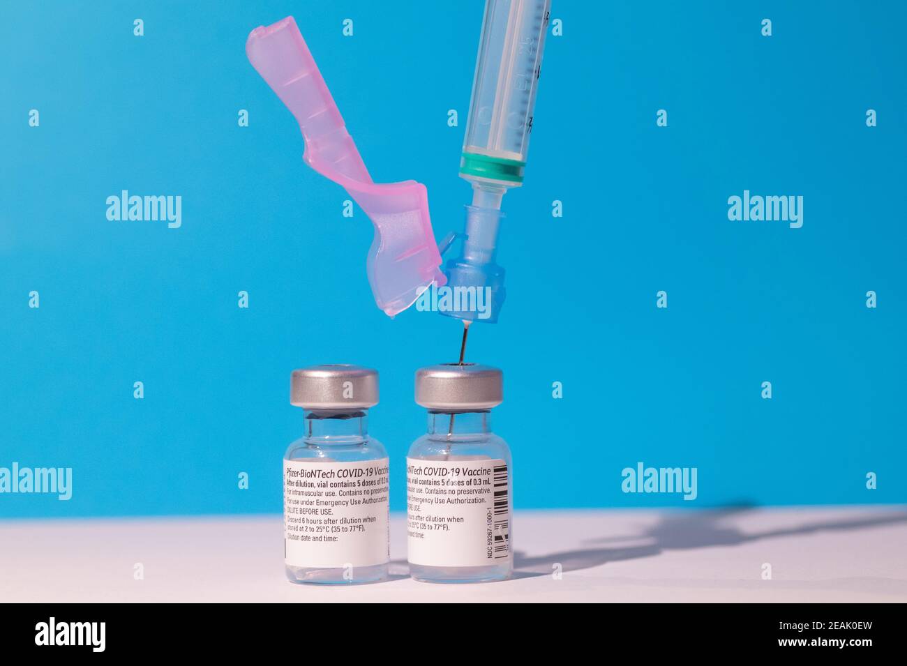 Two vials of Pfizer - BioNTech COVID-19 vaccine for coronavirus treatment with a syringe Stock Photo