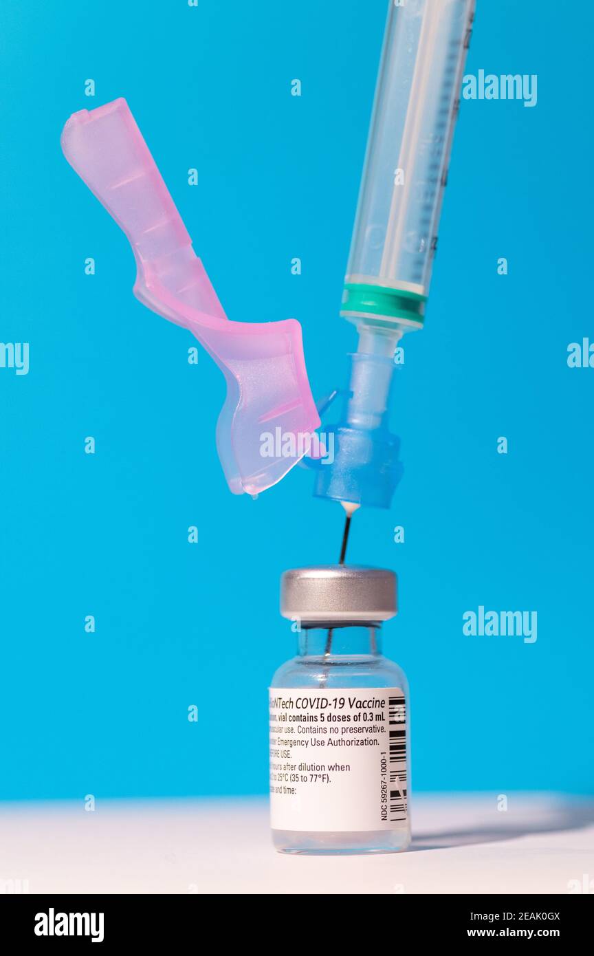 A vial of Pfizer - BioNTech COVID-19 vaccine for coronavirus treatment with a syringe Stock Photo