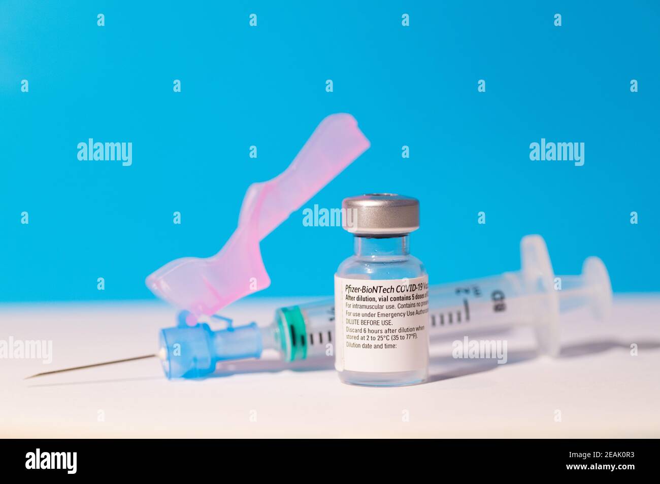 A vial of Pfizer - BioNTech COVID-19 vaccine for coronavirus treatment with a syringe Stock Photo