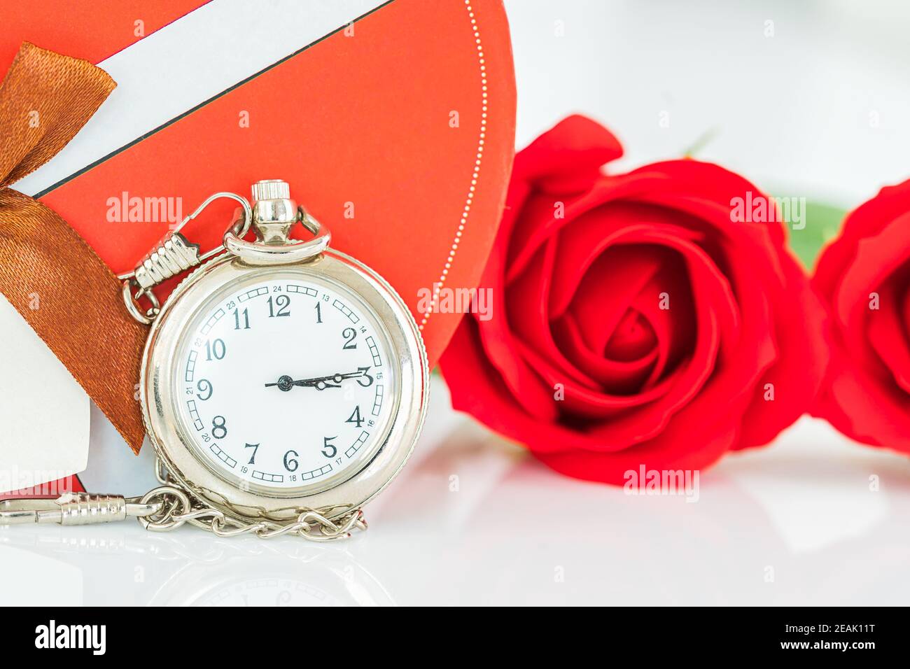 Close up pocket watch and red roses flower Stock Photo