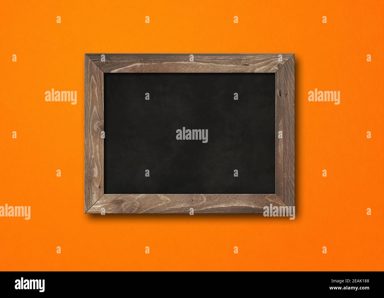 Old rustic black board isolated on orange background Stock Photo