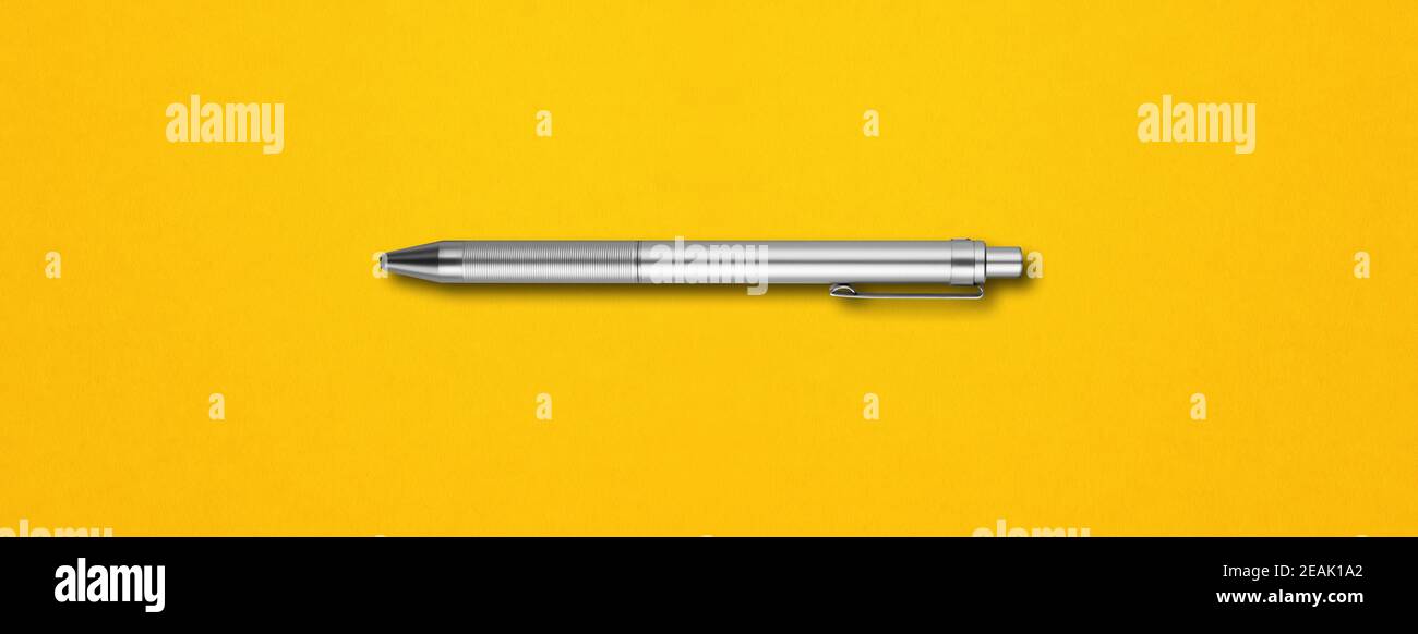 Metal pen isolated on yellow background Stock Photo