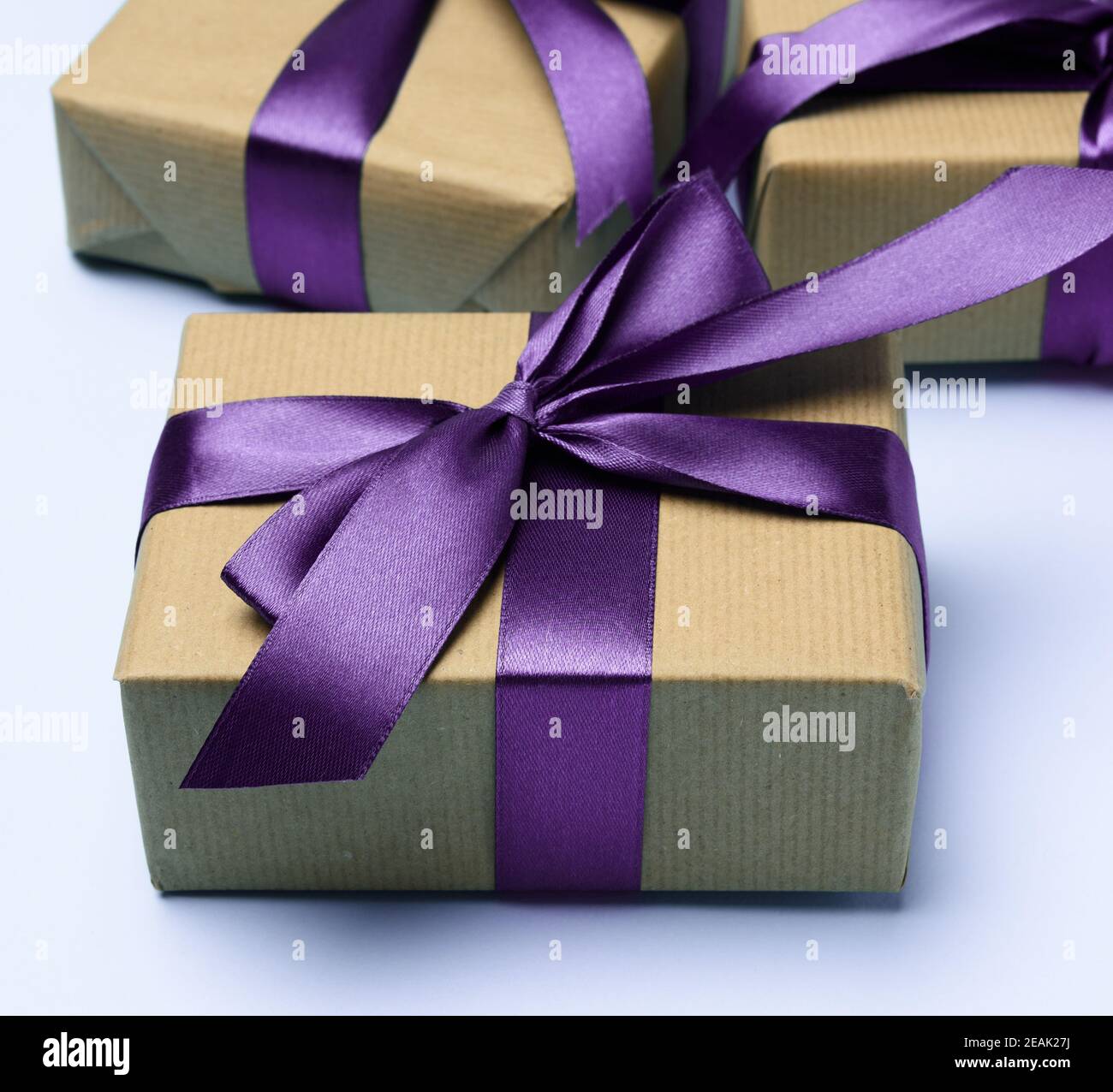 box wrapped in brown paper and tied with a purple silk ribbon Stock ...