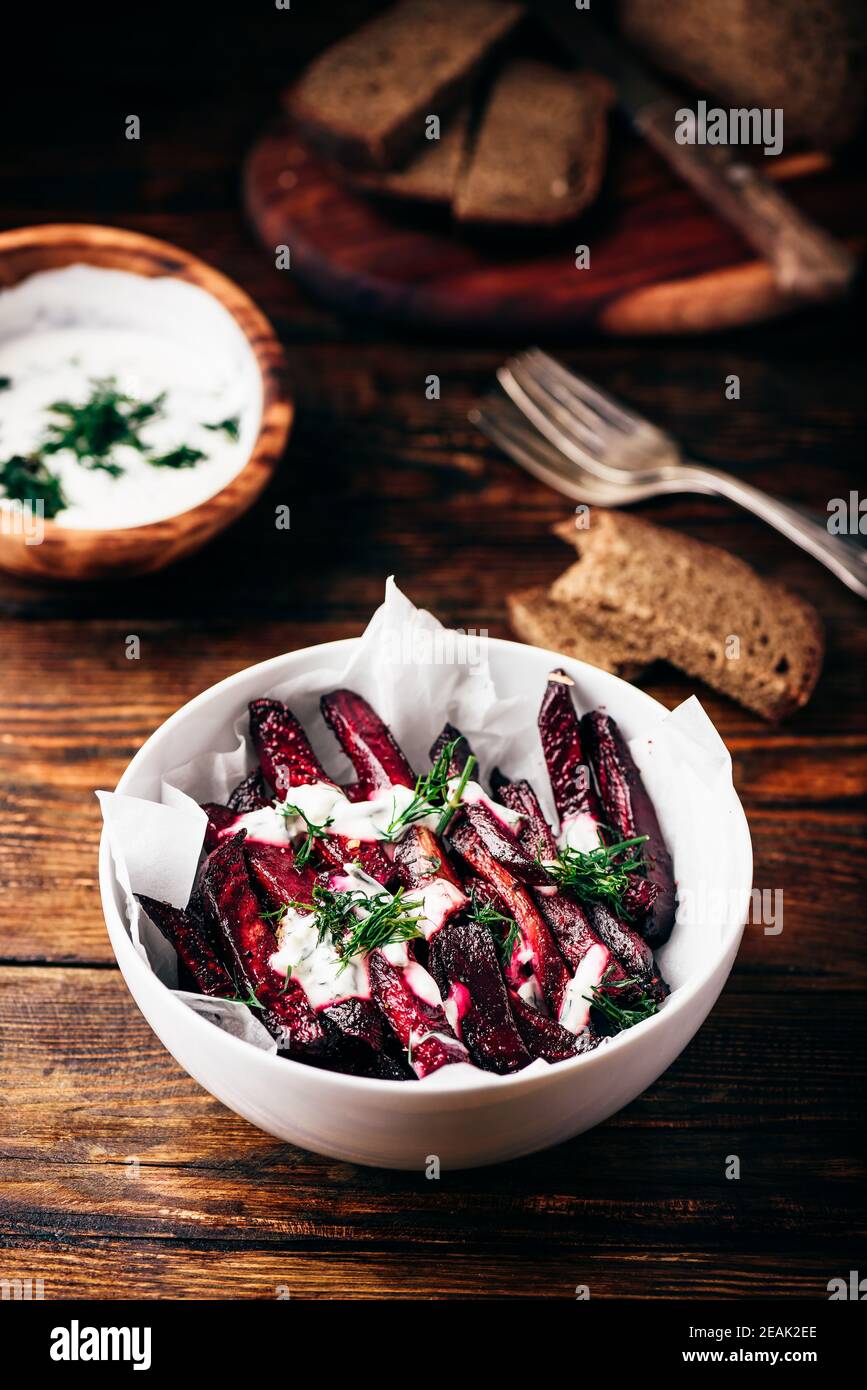 Oven baked beet fries with greek yogurt and dill Stock Photo