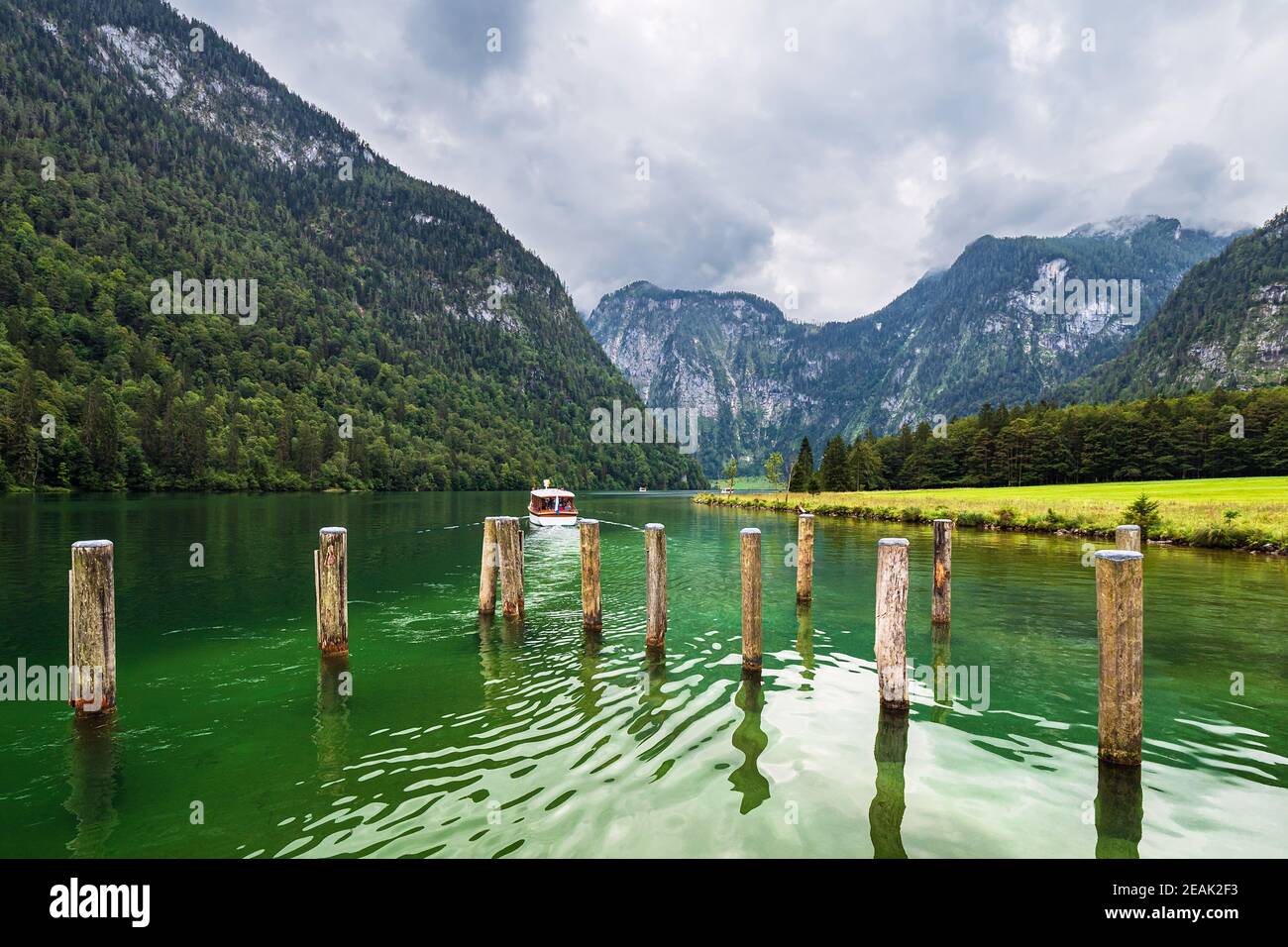 Lake Koenigssee with rocks and excursion boat in the Berchtesgaden Alps