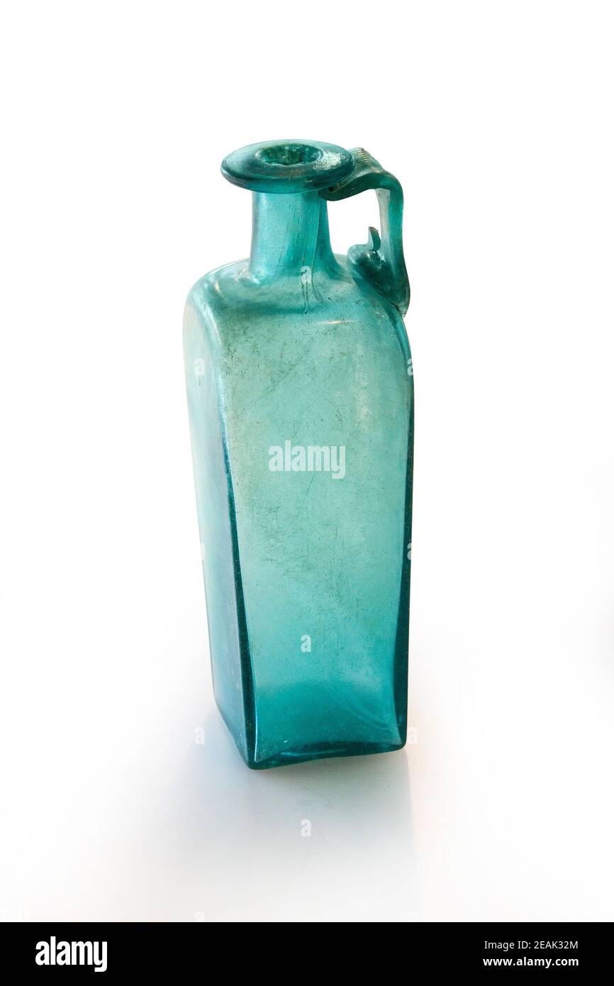 Ancient Roman square bottle with handle from molten glass. 3rd and 4th centuries. Clipping path for design purpopes. Stock Photo