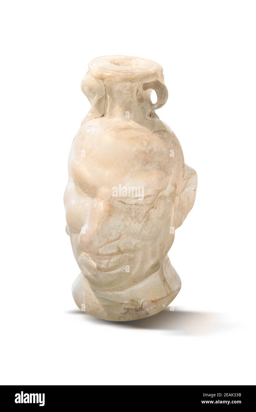 Roman head vessell with grotesque face. Mould-blown Glass. Clipping path for disign purpose. In the 3rd and 4,h centuries AD, glass vessels were produ Stock Photo