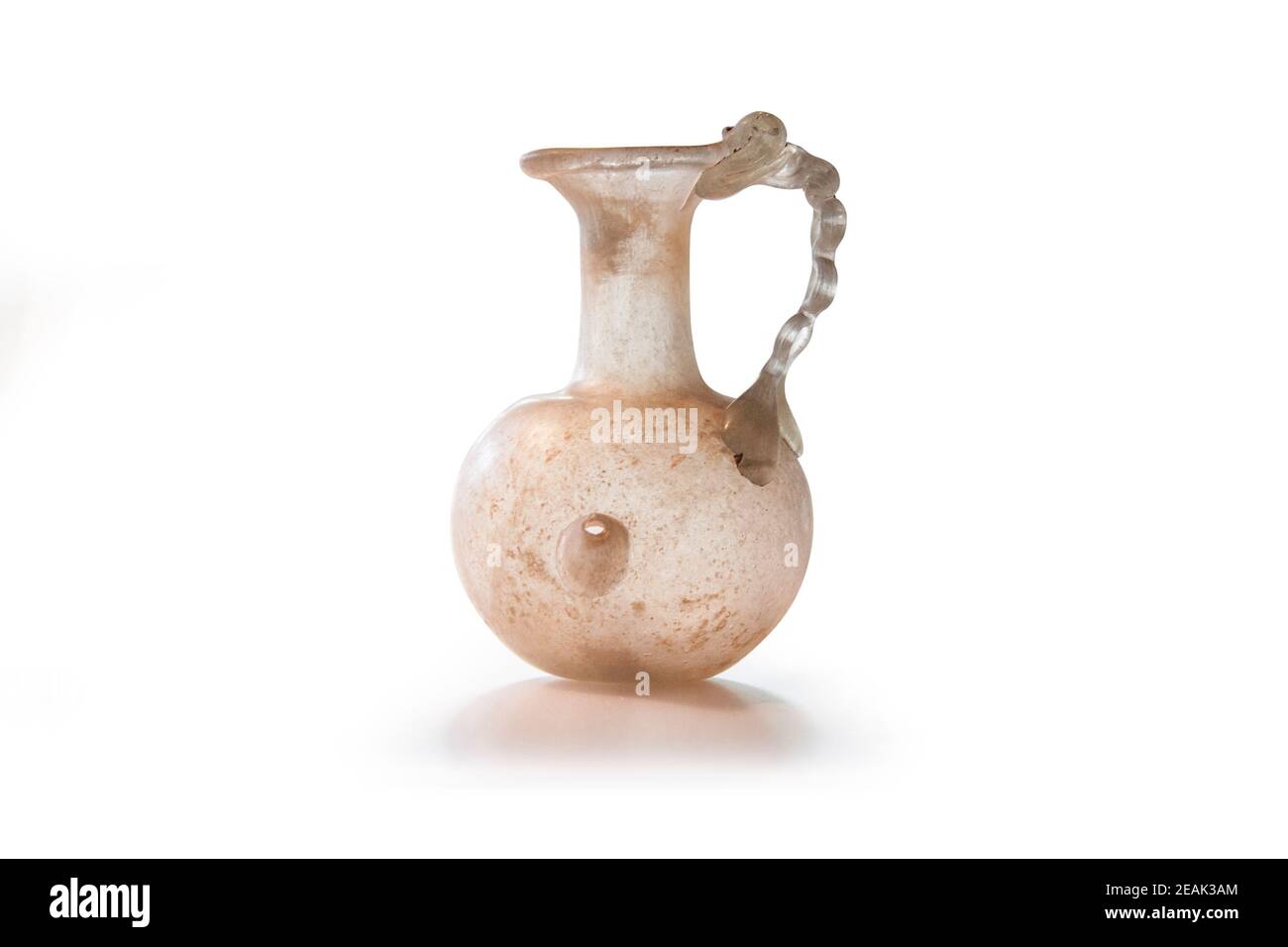Ancient Roman jug with chain handle. Natural-coloured Glass of the 1st and 2nd centuries AD. Clipping path for design purposes. Stock Photo