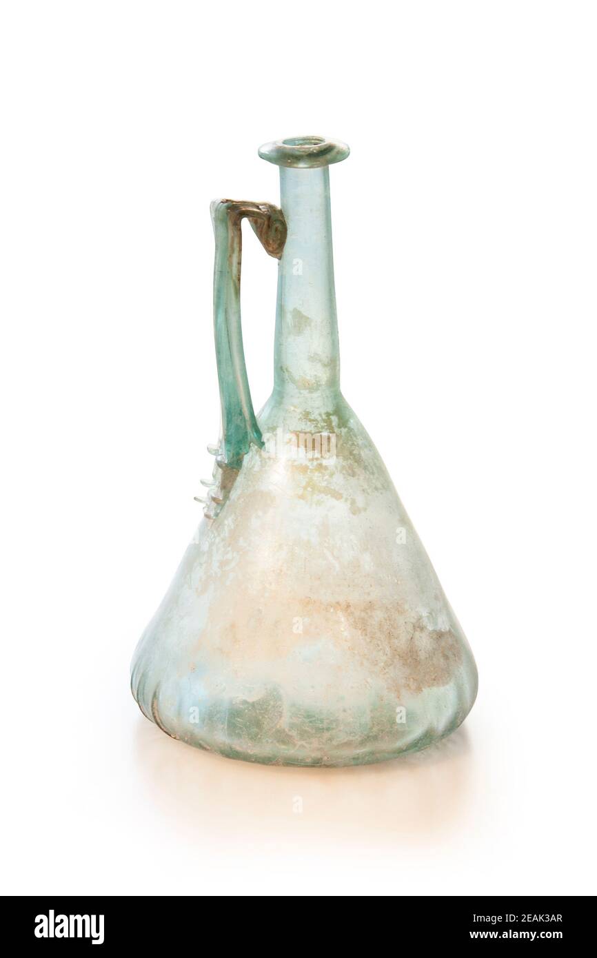 Ancient Roman jug  with rolled wall. Natural-coloured Glass of the 1st and 2nd centuries AD. Clipping path for design purposes. Stock Photo