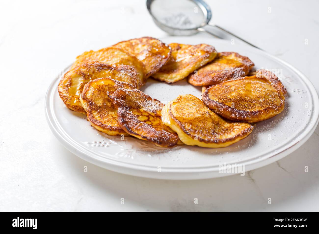 Homemade low calarie curd cheese pancakes on white plate Stock Photo
