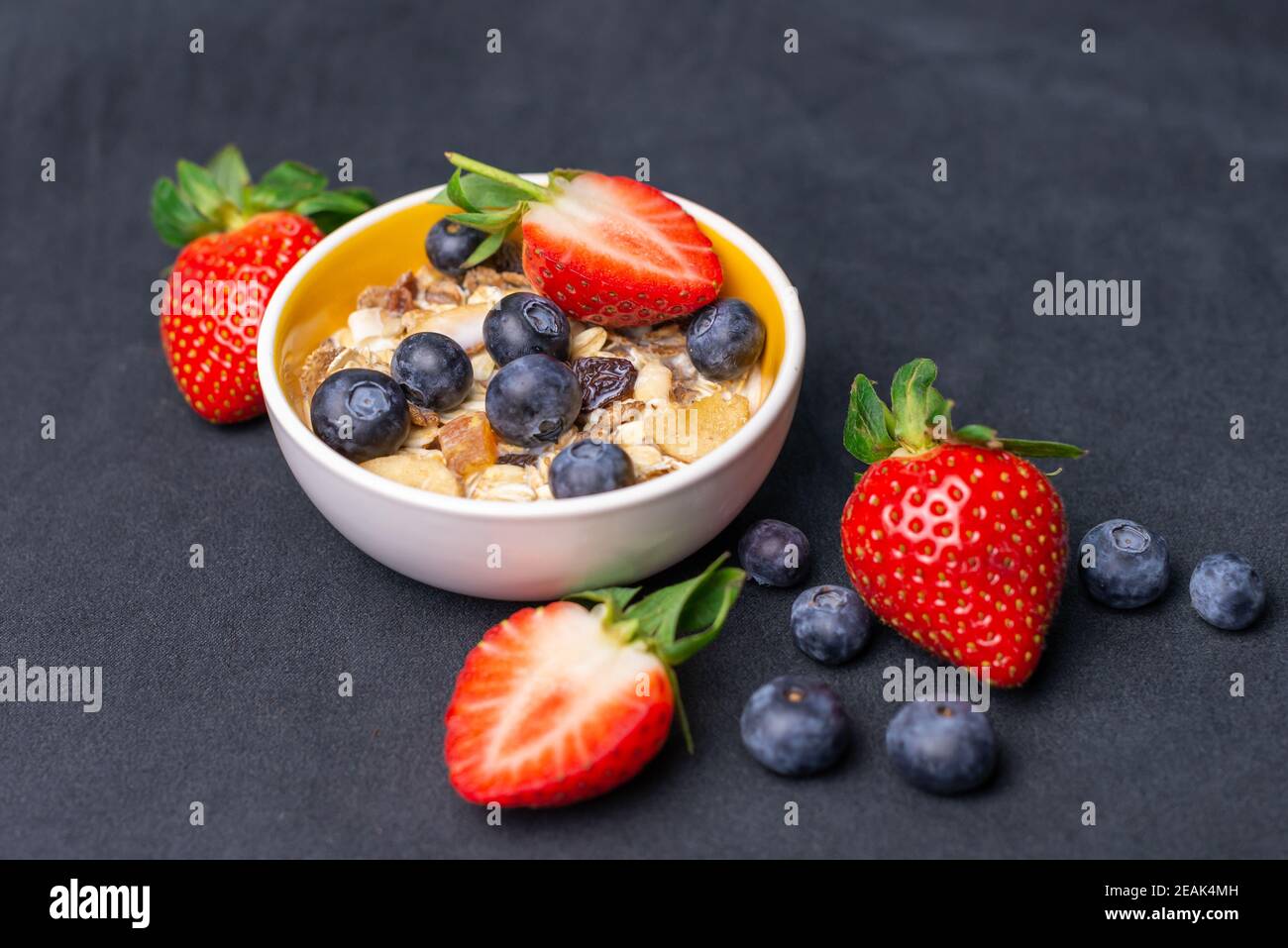 Fruit and Nut muesli with Strawberries and Blueberries. Organic Milk. Stock Photo