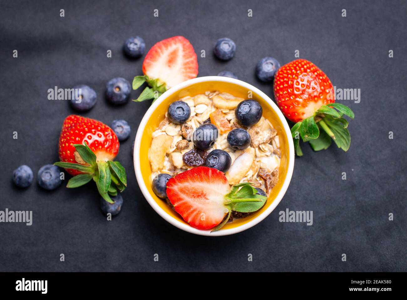 Fruit and Nut muesli with Strawberries and Blueberries. Organic Milk. Stock Photo