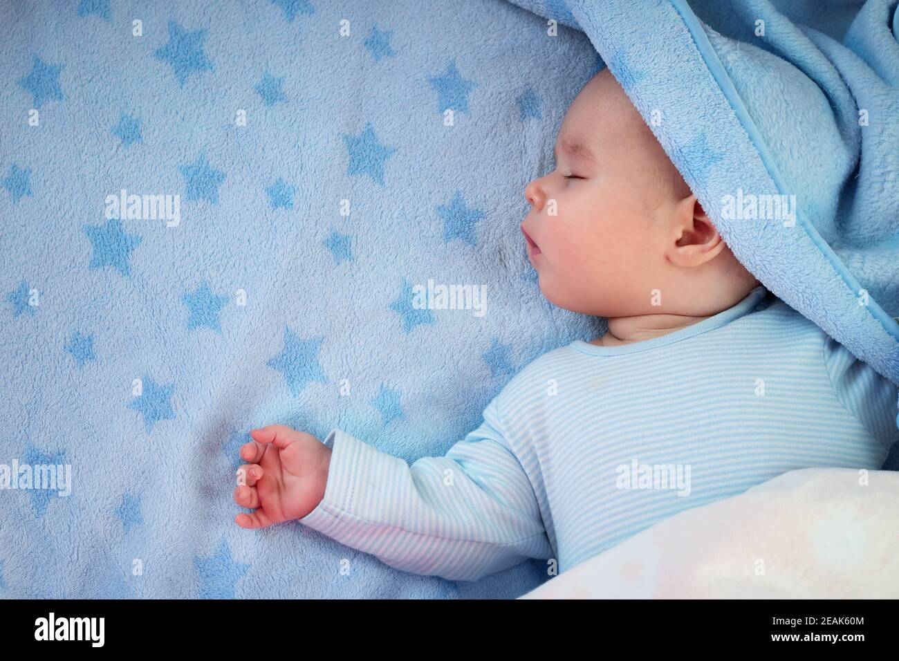 three month old baby sleeping on blue blanket Stock Photo Alamy
